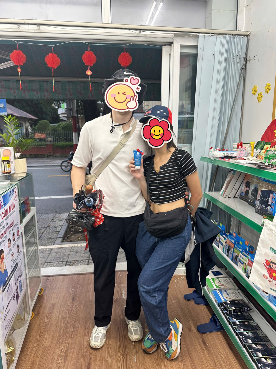 Happy international customers interacting with English-speaking staff at MIA Pharmacy in Hue