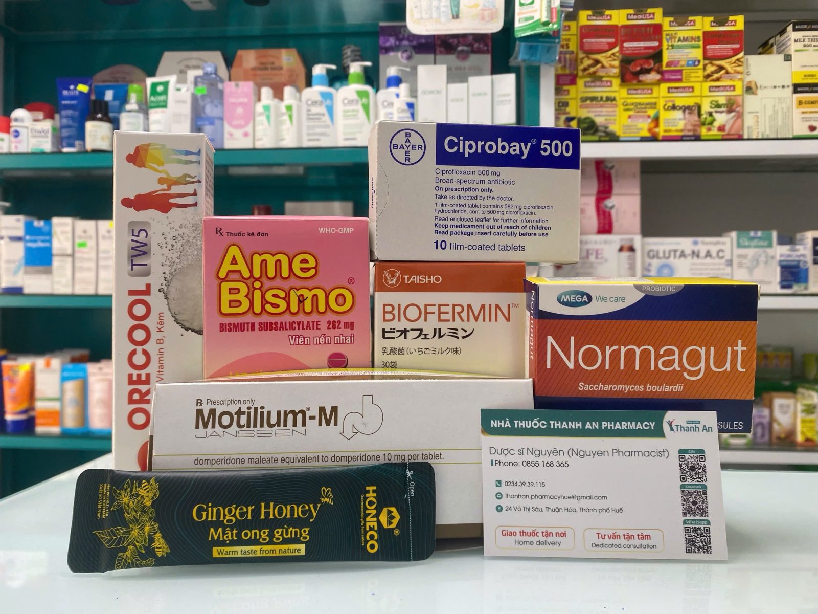 Ciprobay 500, AmeBismo, Biofermin, Normagut, Motilium-M, Orecool TW5 and ginger honey products displayed at a pharmacy in Vietnam