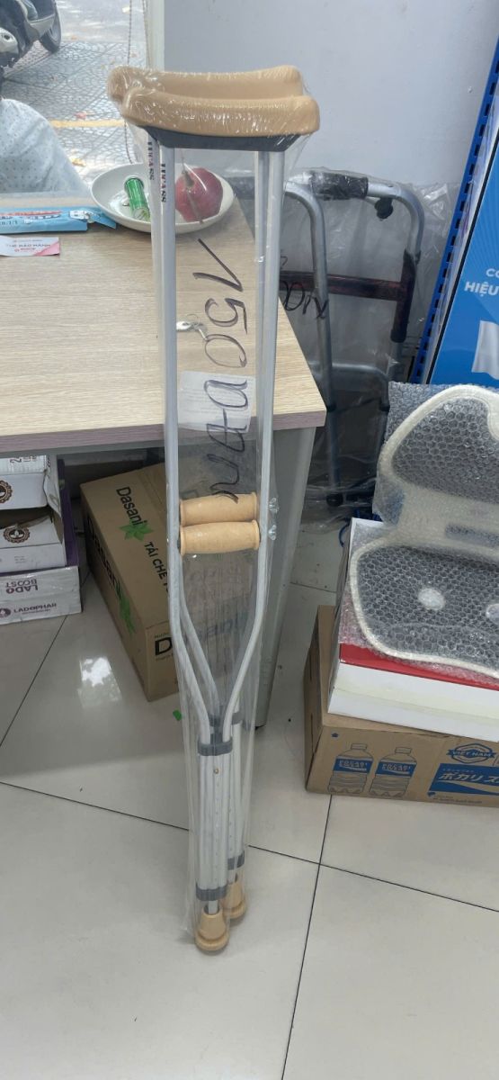Adjustable underarm crutches in Hoi An with a handwritten 150,000 VND price marking