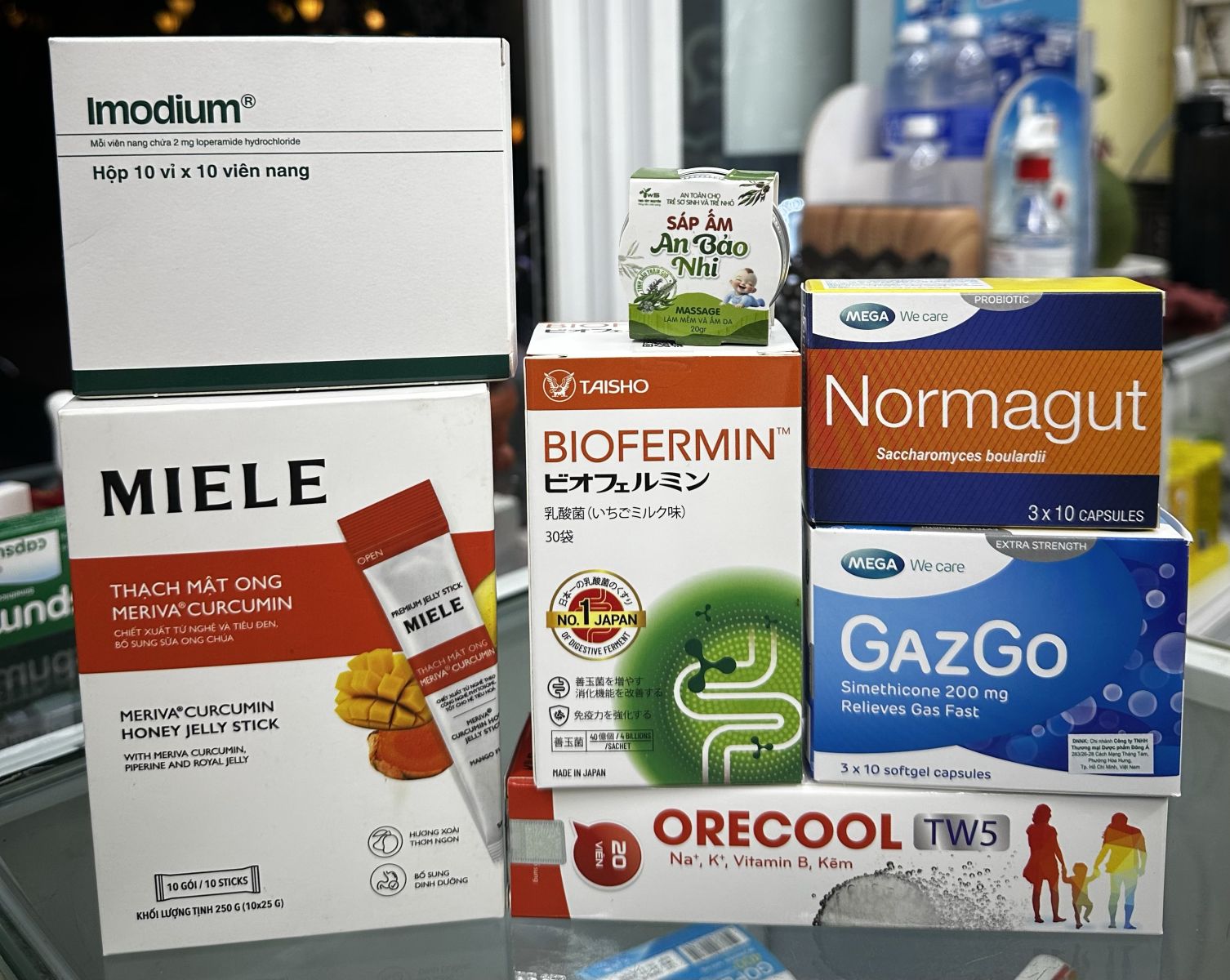 modium, Gazgo, Normagut, Biofermin, Orecool TW5, Miele jelly and An Bao Nhi warming balm displayed on a pharmacy counter